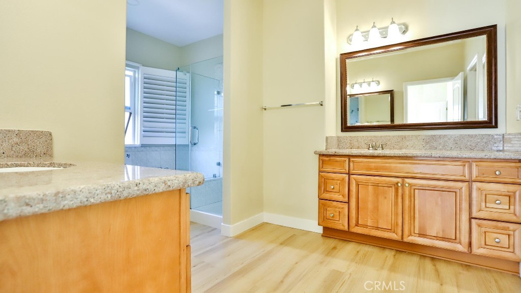 12388 Arrowhead Street Stanton, CA 90680 - Photo 37 of 69 a bathroom with a granite countertop sink and a mirror