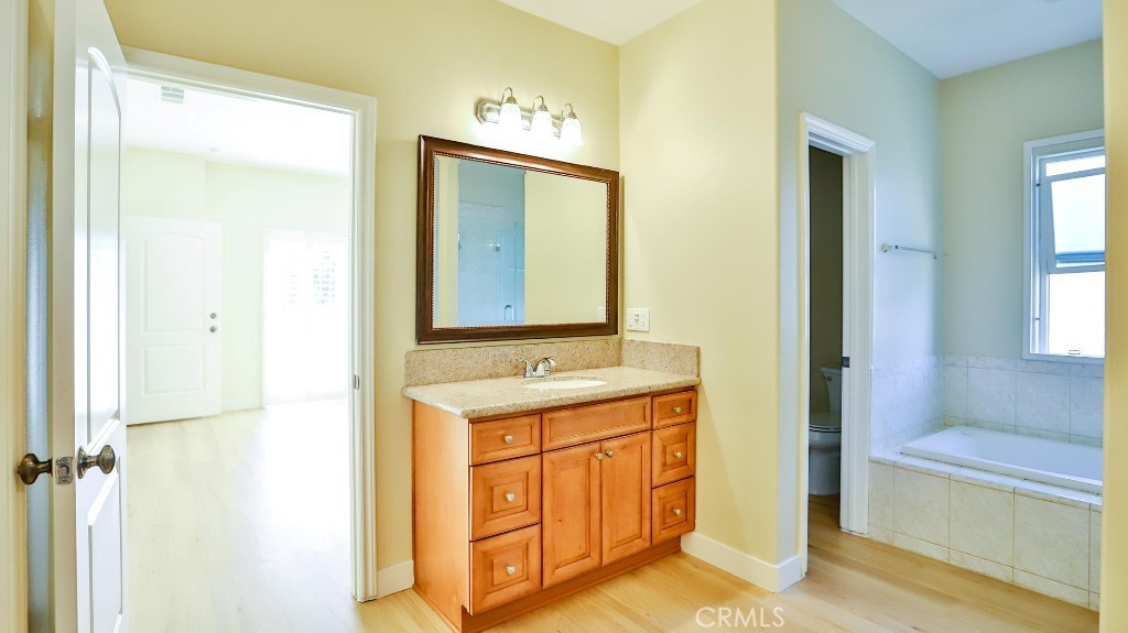 12388 Arrowhead Street Stanton, CA 90680 - Photo 39 of 69 a bathroom with a granite countertop sink and a mirror