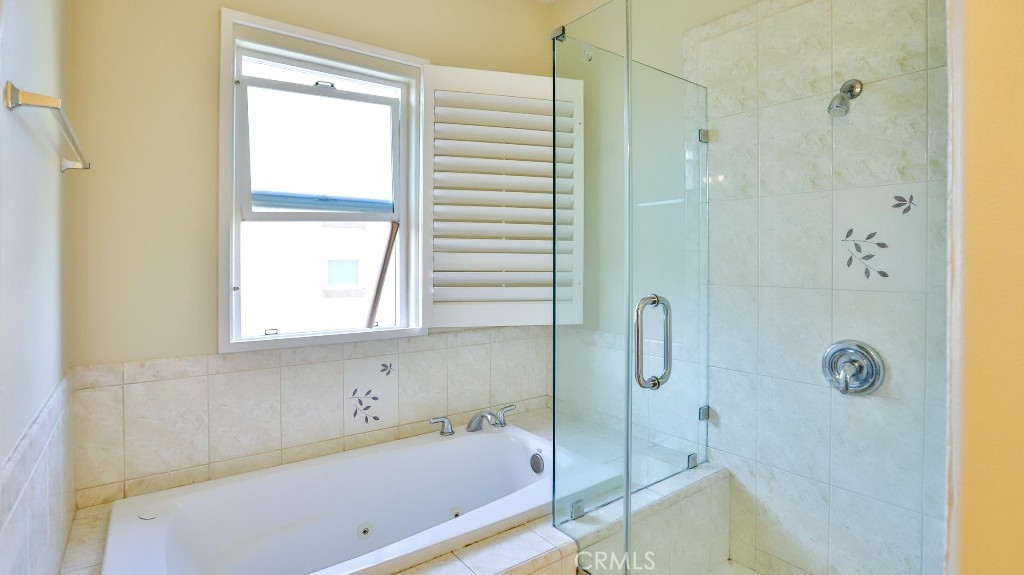 12388 Arrowhead Street Stanton, CA 90680 - Photo 41 of 69 a bathroom with a bathtub and a shower