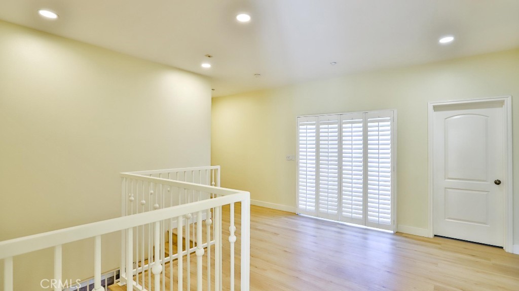 12388 Arrowhead Street Stanton, CA 90680 - Photo 43 of 69 an empty room with wooden floor and windows