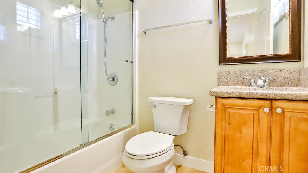 12388 Arrowhead Street Stanton, CA 90680 - Photo 44 of 69 a bathroom with a granite countertop toilet sink and shower