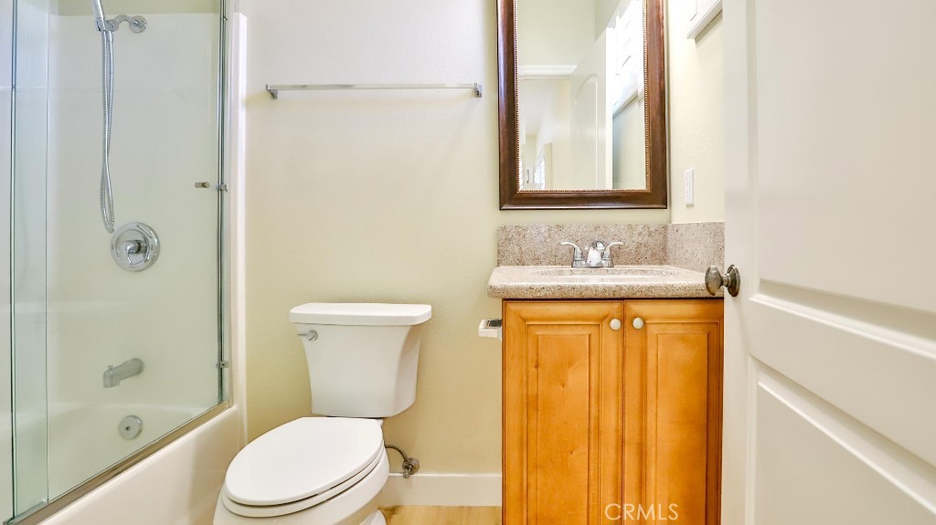 12388 Arrowhead Street Stanton, CA 90680 - Photo 45 of 69 a bathroom with a granite countertop toilet sink and mirror