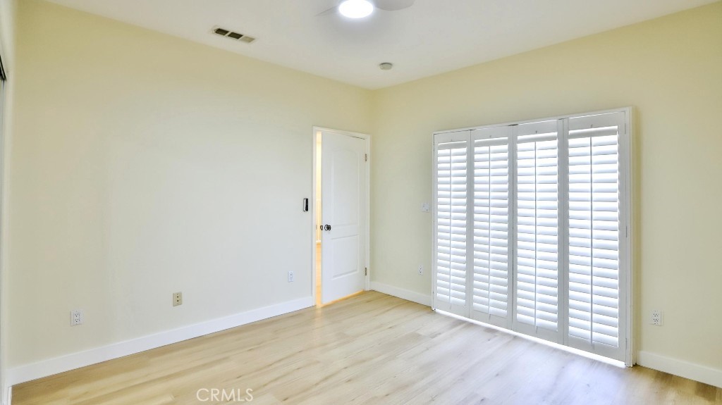 12388 Arrowhead Street Stanton, CA 90680 - Photo 48 of 69 an empty room with wooden floor and windows