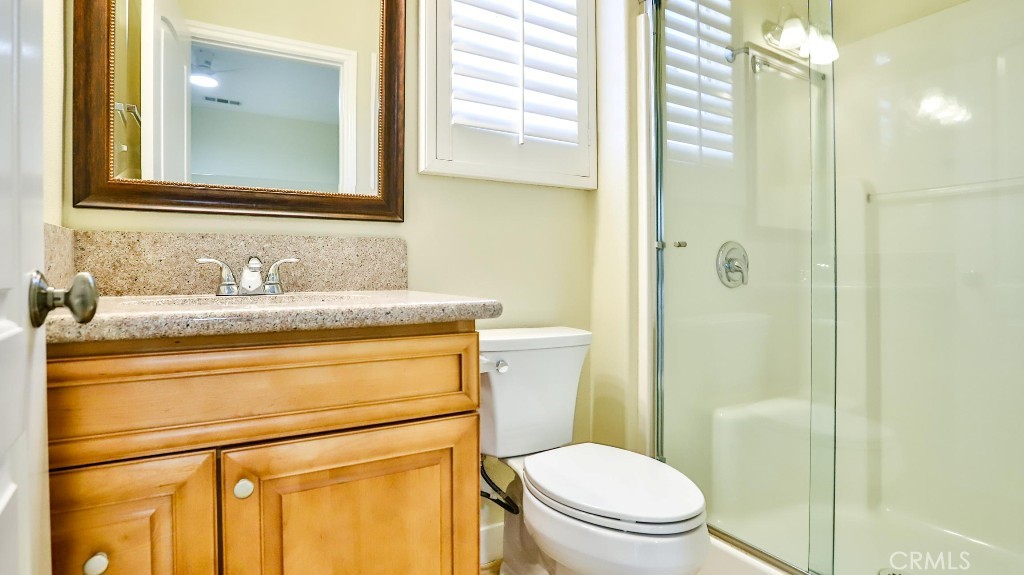 12388 Arrowhead Street Stanton, CA 90680 - Photo 50 of 69 a bathroom with a granite countertop sink toilet and shower