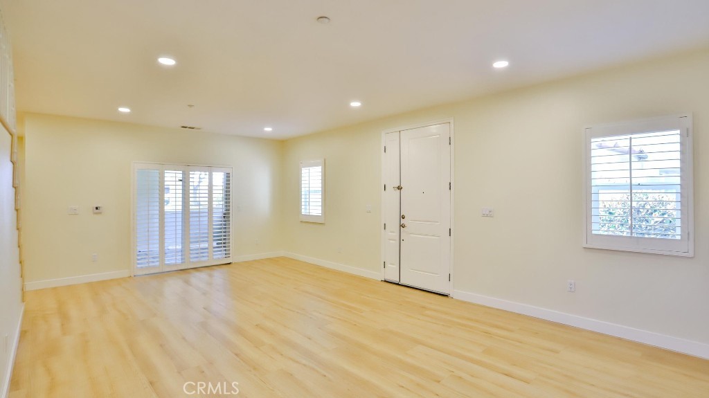 12388 Arrowhead Street Stanton, CA 90680 - Photo 10 of 69 a view of an empty room with wooden floor and a window