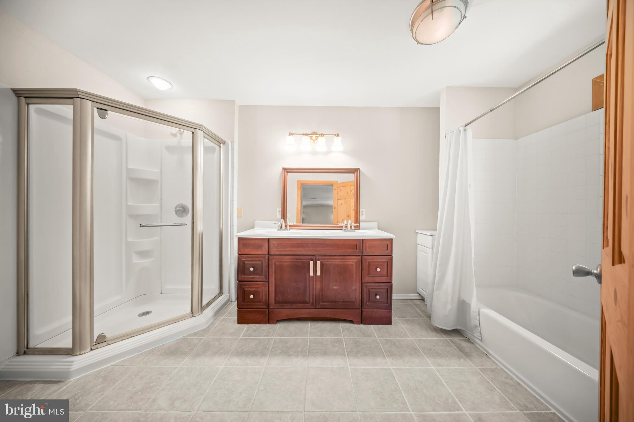 1473 North River Road Yardley, PA 19067 - Photo 29 of 42 a spacious bathroom with a granite countertop sink a mirror and a bathtub
