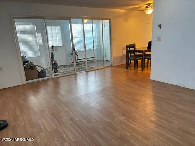 a view of a work space with wooden floor and furniture