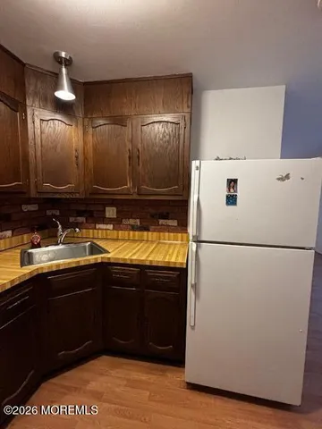a view of kitchen with cabinets and wooden floor