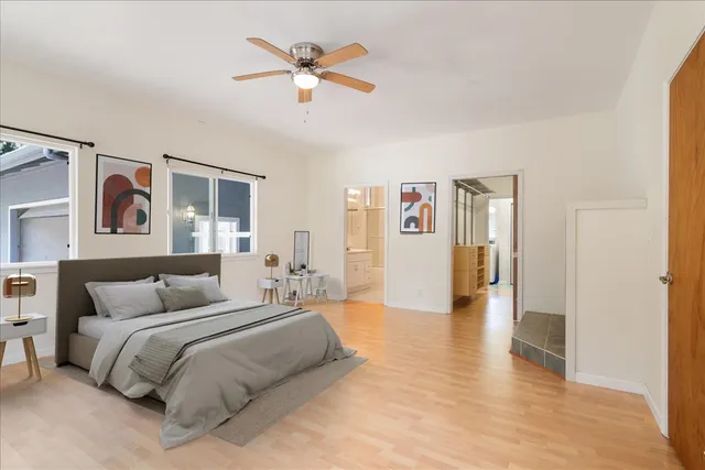 a bedroom with a large bed and a chandelier