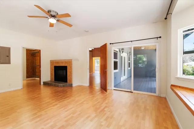 a view of an empty room with glass door and a window
