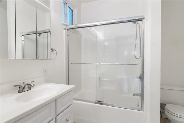 a bathroom with a shower and a sink