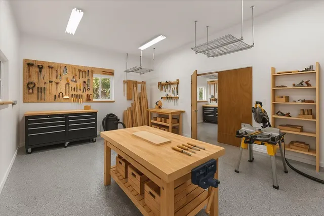 a kitchen that has a stove a table and chairs in it