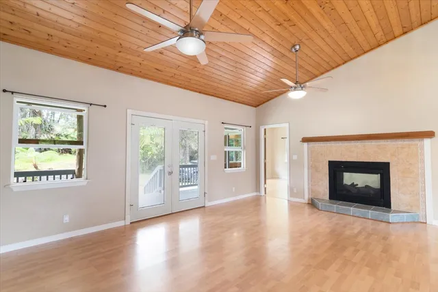 a view of an empty room with a fireplace and a window