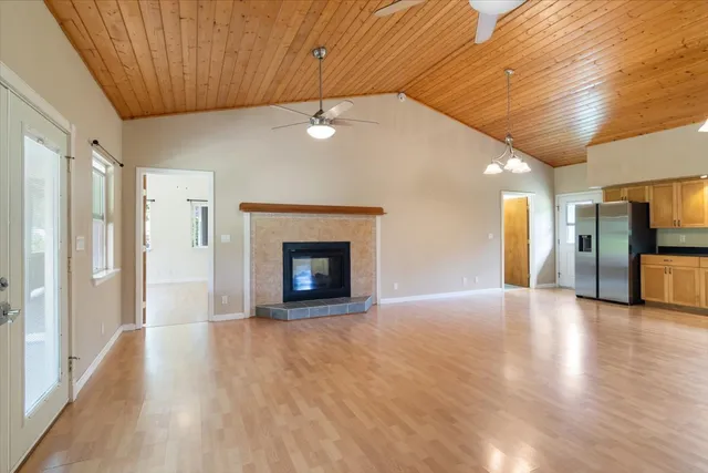 a view of an empty room with a fireplace and a window