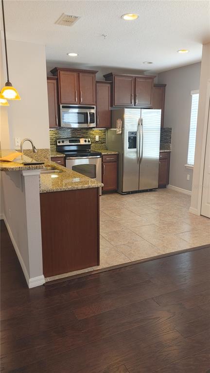 455 Old Farm Lane Winter Springs, FL 32708 - Photo 14 of 38 a kitchen with stainless steel appliances granite countertop a stove a sink and a refrigerator
