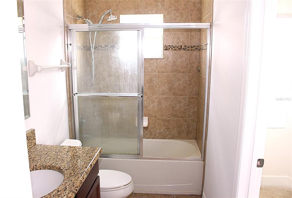455 Old Farm Lane Winter Springs, FL 32708 - Photo 16 of 38 a bathroom with a granite countertop bathtub shower sink vanity and toilet
