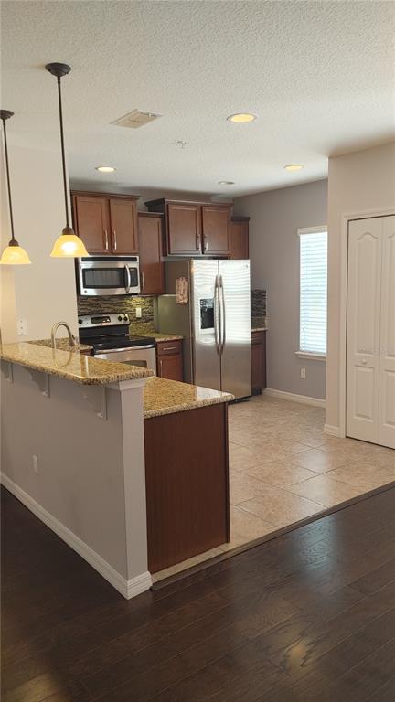 455 Old Farm Lane Winter Springs, FL 32708 - Photo 23 of 38 a kitchen with stainless steel appliances granite countertop a refrigerator a stove and a sink