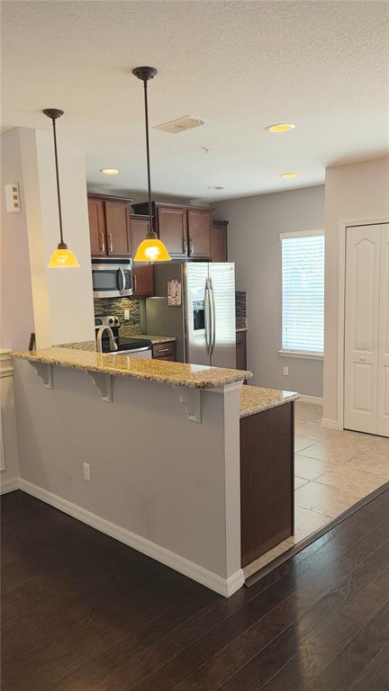 455 Old Farm Lane Winter Springs, FL 32708 - Photo 27 of 38 a room with kitchen island stainless steel appliances wooden floor and window