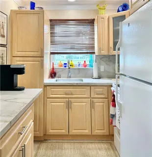 a bathroom with a sink cabinets and a window