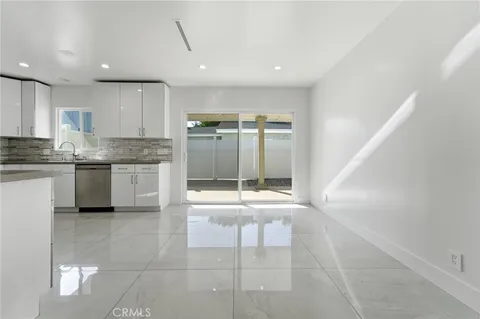 a open kitchen with stainless steel appliances granite countertop a stove and a refrigerator
