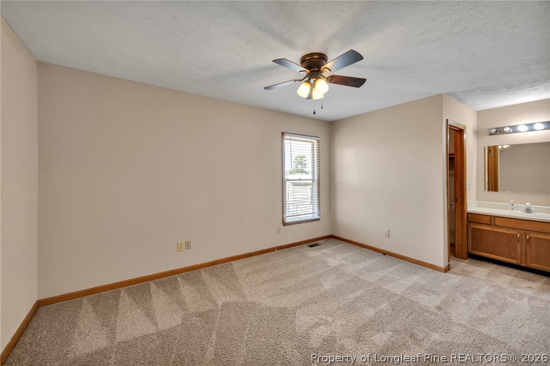 5262 Marvin Drive Spring Lake, NC 28390 - Photo 12 of 23 an empty room with chandelier fan and windows
