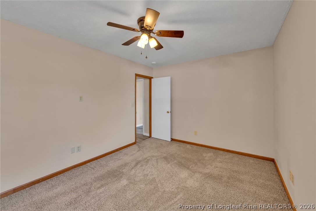 5262 Marvin Drive Spring Lake, NC 28390 - Photo 13 of 23 an empty room with a ceiling fan and a window