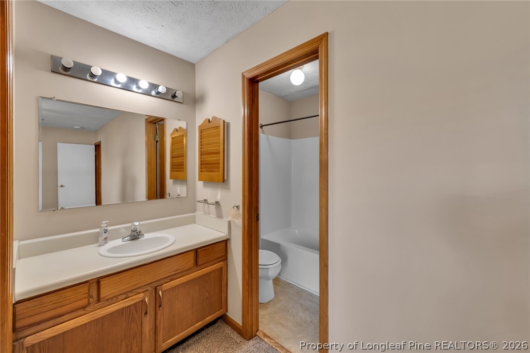 5262 Marvin Drive Spring Lake, NC 28390 - Photo 14 of 23 a bathroom with a double vanity sink and a mirror