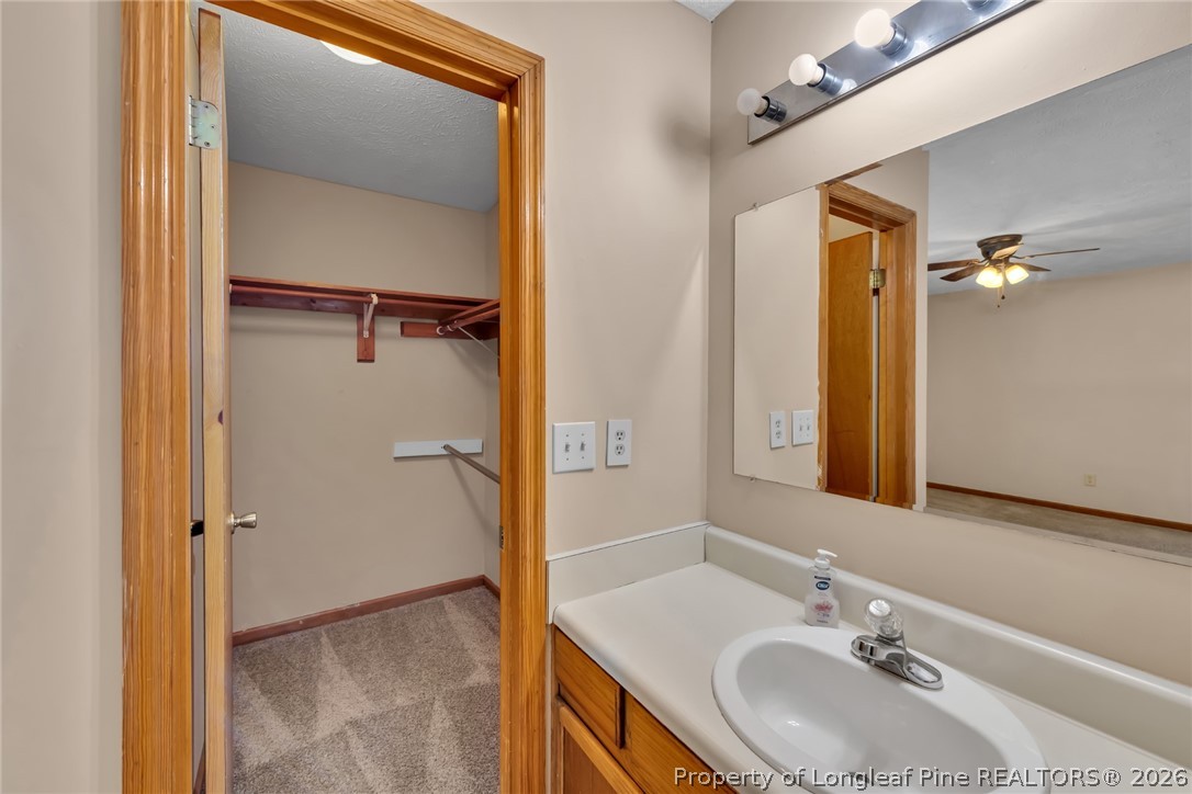 5262 Marvin Drive Spring Lake, NC 28390 - Photo 15 of 23 a bathroom with a sink and a mirror