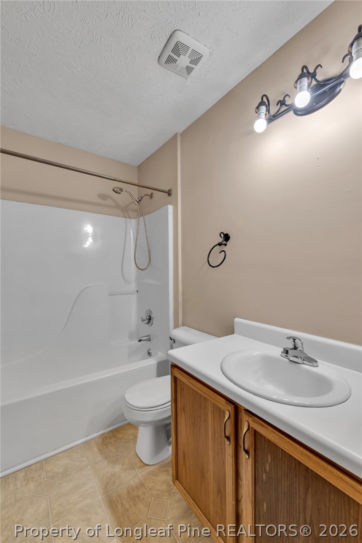 5262 Marvin Drive Spring Lake, NC 28390 - Photo 18 of 23 a bathroom with a sink a toilet and shower