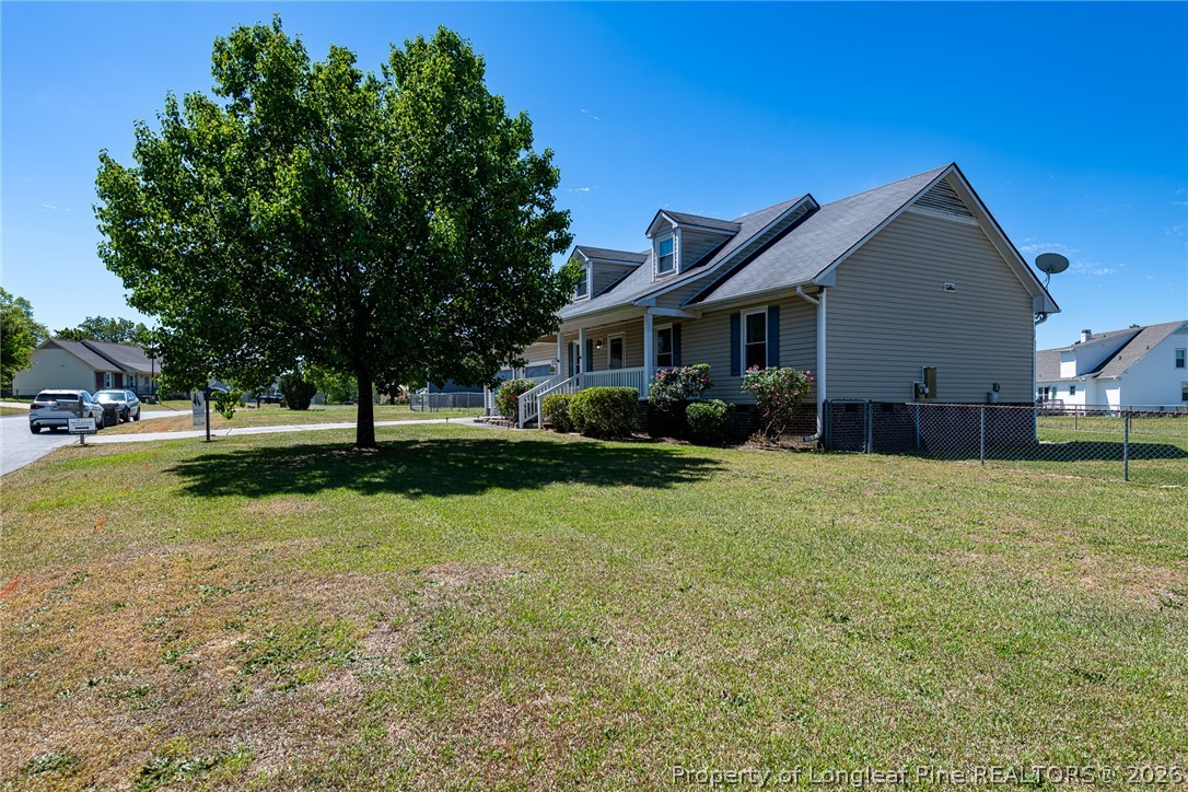 5262 Marvin Drive Spring Lake, NC 28390 - Photo 21 of 23 a view of a house with a big yard and large trees