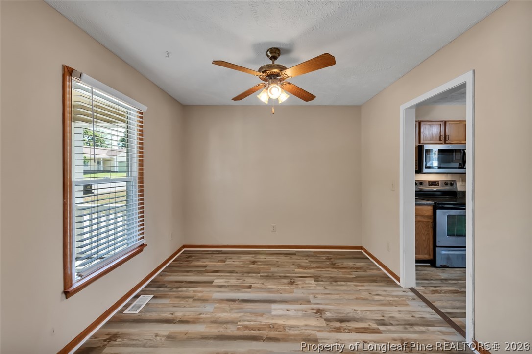 5262 Marvin Drive Spring Lake, NC 28390 - Photo 4 of 23 a view of empty room with wooden floor and fan