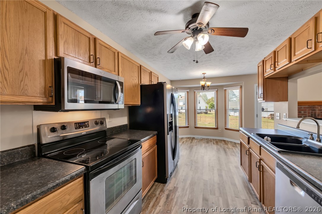 5262 Marvin Drive Spring Lake, NC 28390 - Photo 5 of 23 a kitchen with stainless steel appliances granite countertop a stove microwave and a sink