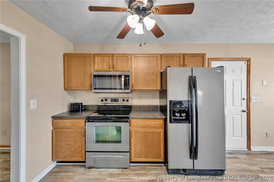 5262 Marvin Drive Spring Lake, NC 28390 - Photo 6 of 23 a kitchen with stainless steel appliances granite countertop a refrigerator a stove and a sink