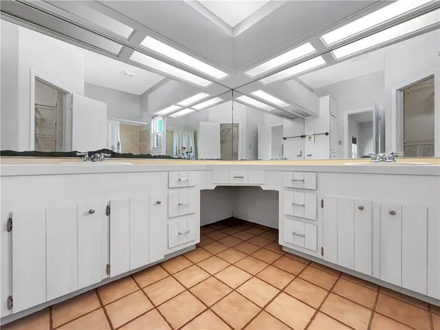 a spacious bathroom with a double vanity sink mirror and