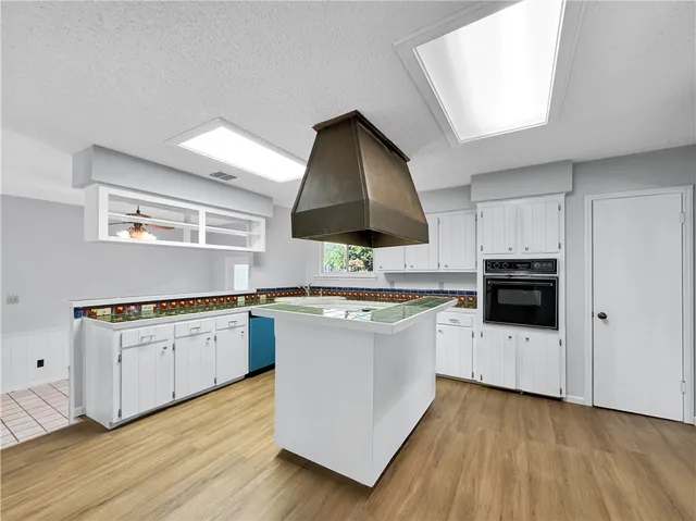 a kitchen with stainless steel appliances a stove a sink and a microwave