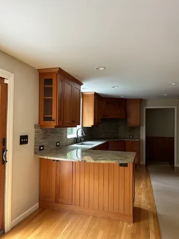 a kitchen with stainless steel appliances granite countertop a sink a stove and a refrigerator
