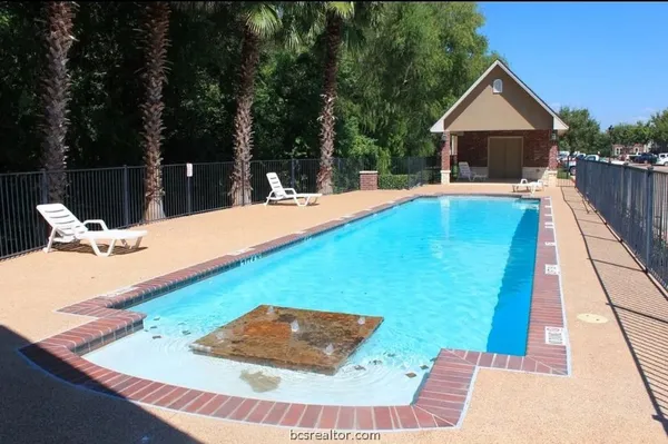 a view of swimming pool with a lounge chairs