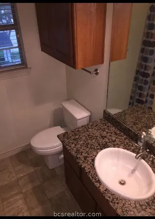 a bathroom with a sink and toilet