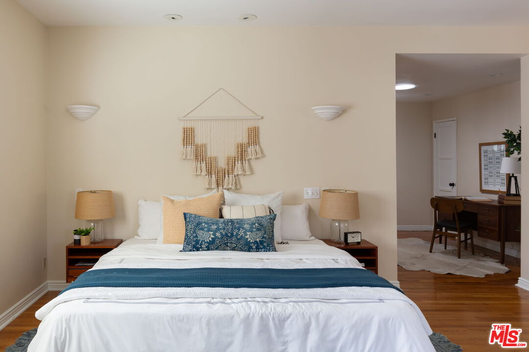 3810 Hauser Boulevard Los Angeles, CA 90008 - Photo 16 of 32 a bedroom with a bed and wooden floor