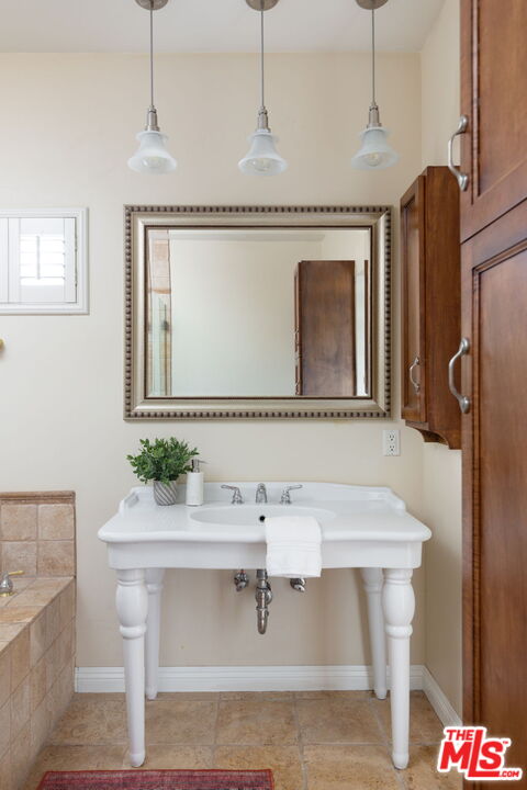 3810 Hauser Boulevard Los Angeles, CA 90008 - Photo 22 of 32 a bathroom with a sink and a mirror