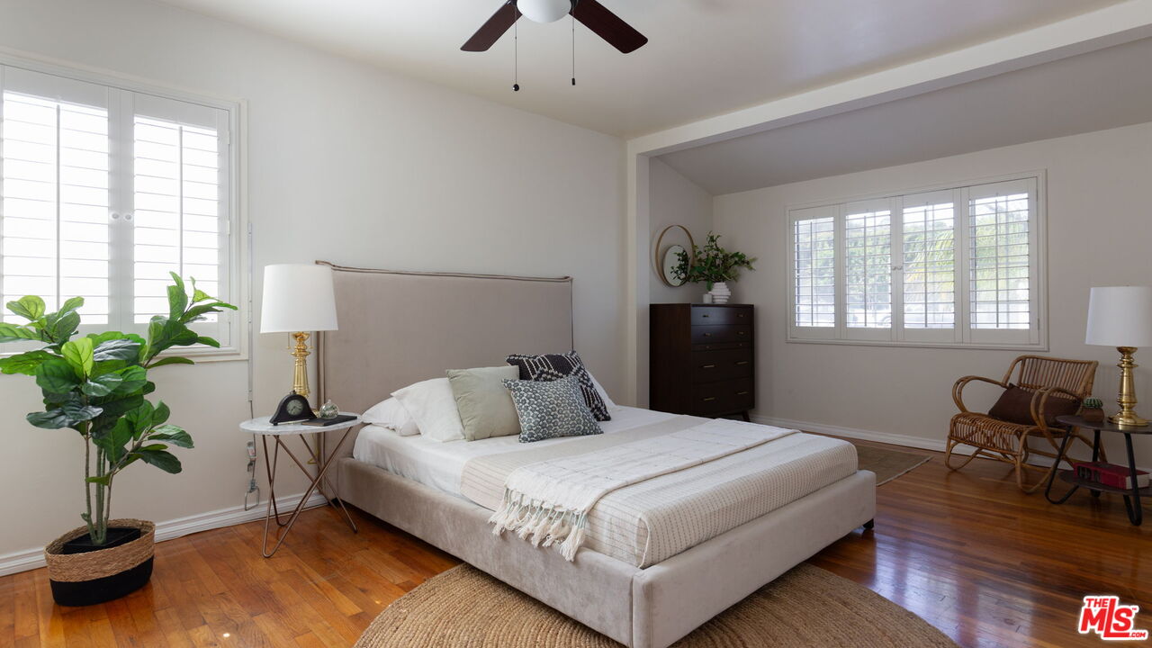 3810 Hauser Boulevard Los Angeles, CA 90008 - Photo 25 of 32 a bedroom with a bed potted plant on dresser and a window