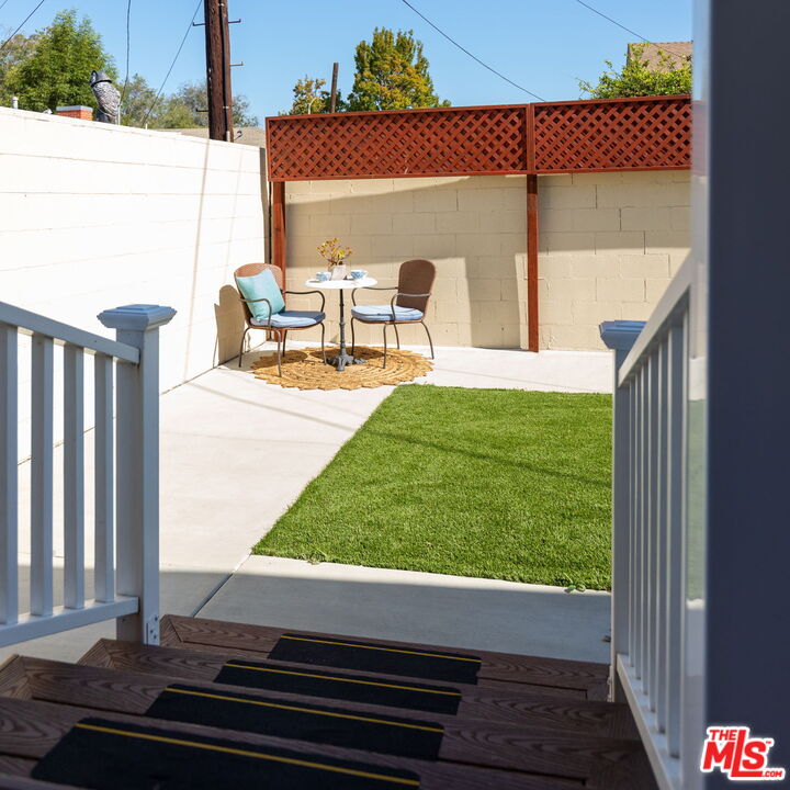 3810 Hauser Boulevard Los Angeles, CA 90008 - Photo 29 of 32 a view of a patio with table and chairs and potted plants