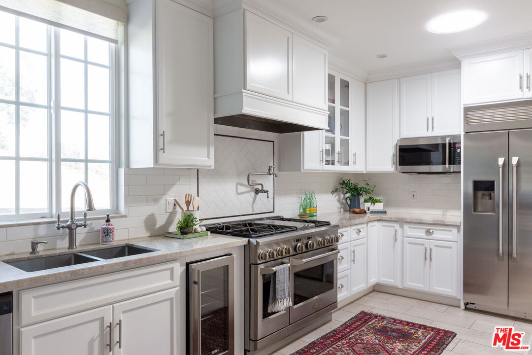 3810 Hauser Boulevard Los Angeles, CA 90008 - Photo 9 of 32 a kitchen with a sink stove top oven and refrigerator