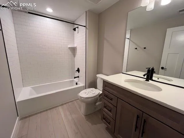 a bathroom with a sink a toilet a mirror and shower