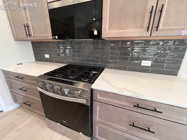 a kitchen with granite countertop a stove and a sink
