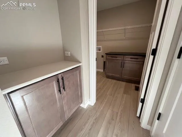 a view of walk in closet with empty racks