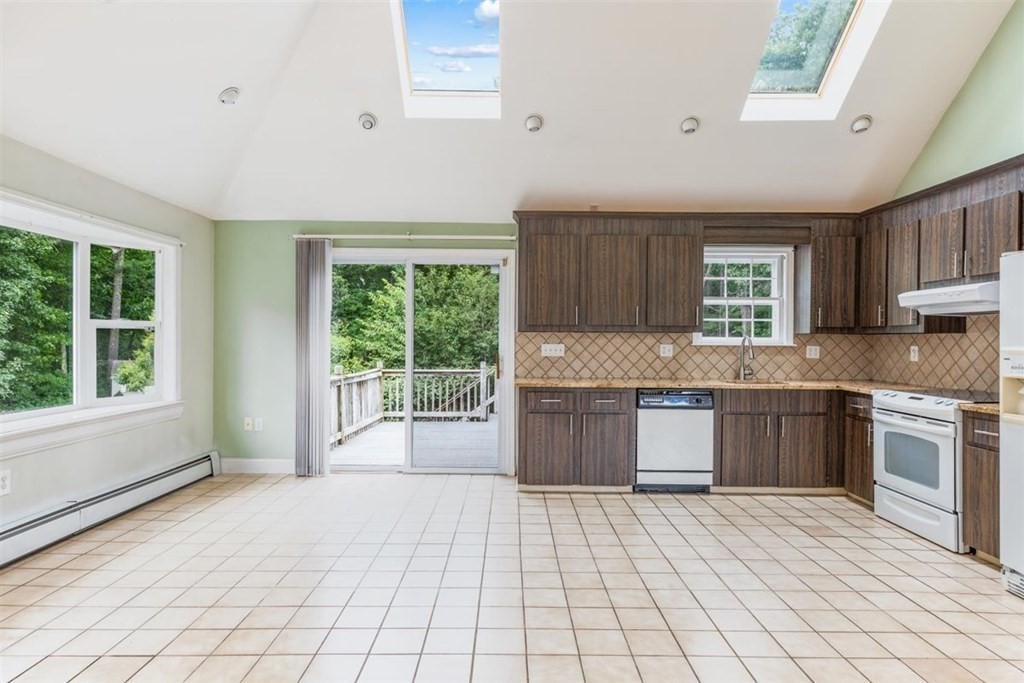 17 Brentwood Road Kingston, MA 02364 - Photo 11 of 33 a large kitchen with kitchen island granite countertop a stove a sink dishwasher and a wooden cabinets