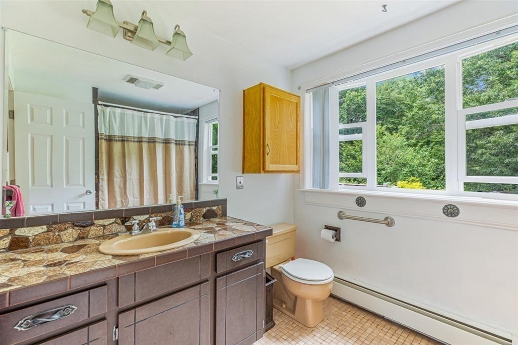 17 Brentwood Road Kingston, MA 02364 - Photo 16 of 33 a bathroom with a granite countertop sink toilet a large mirror a bathtub and window