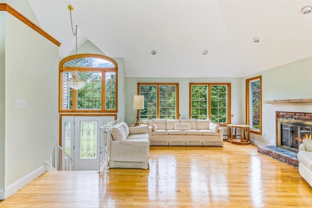 17 Brentwood Road Kingston, MA 02364 - Photo 6 of 33 a living room with fireplace furniture and a floor to ceiling window