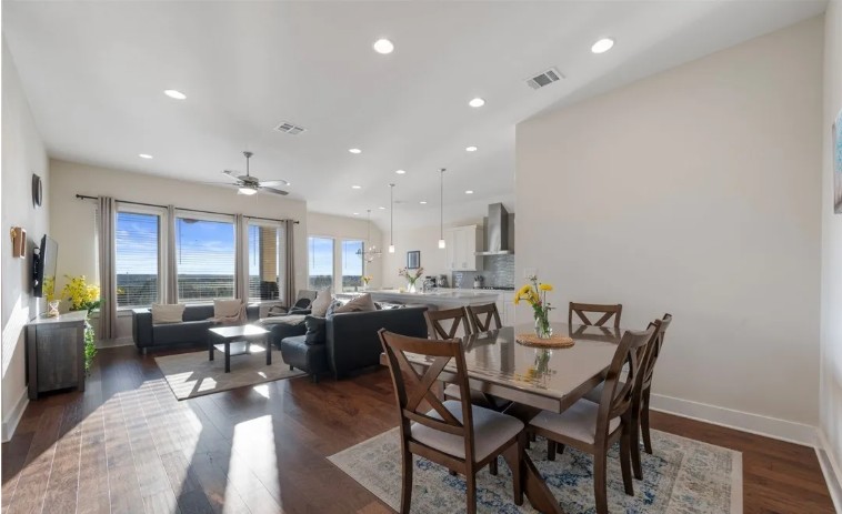 344 Pisa Lane Georgetown, TX 78628 - Photo 13 of 39 Gleaming hardwood floors and recessed lighting anchor this open-concept main living space.